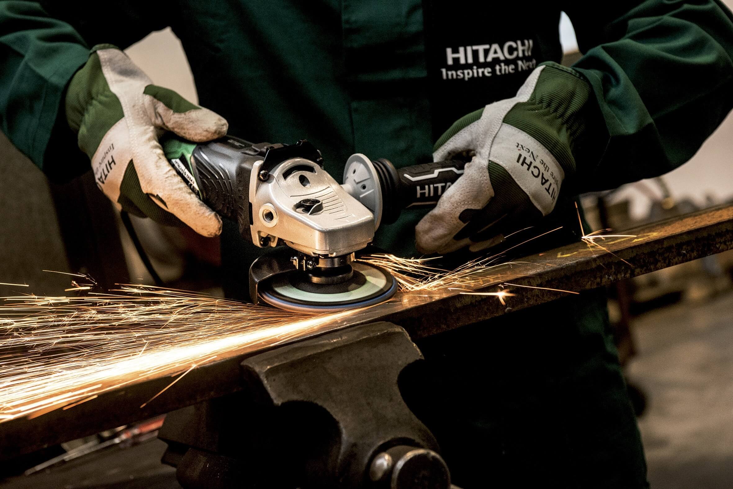 person using sander on a piece of wood