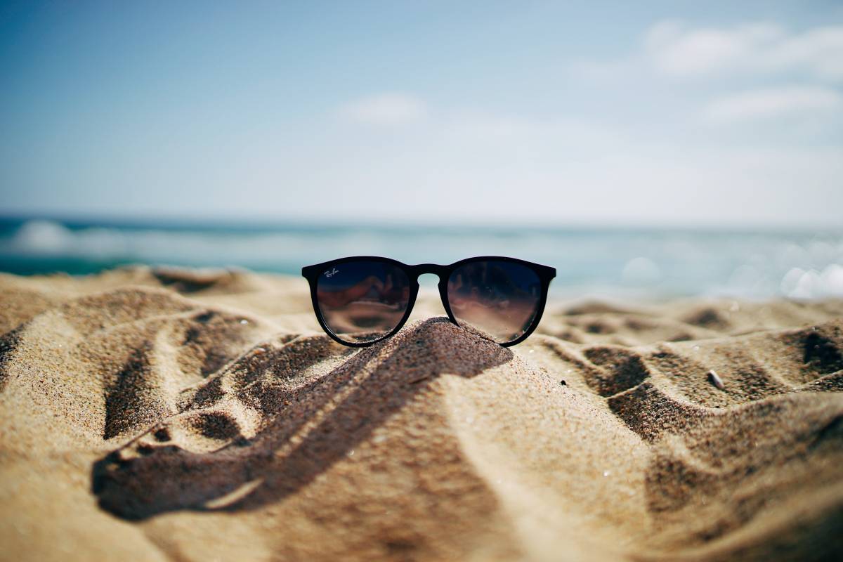 sunglasses on pile of sand