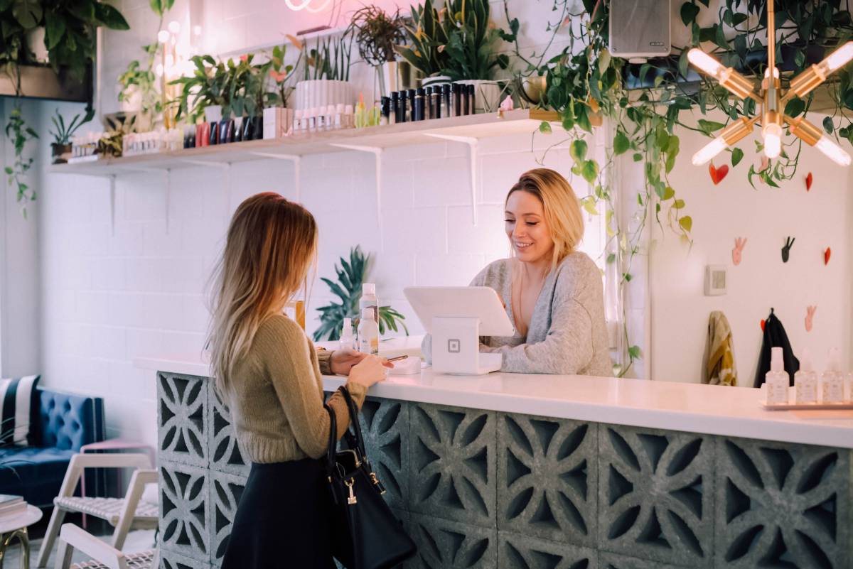 woman serving customer in shop