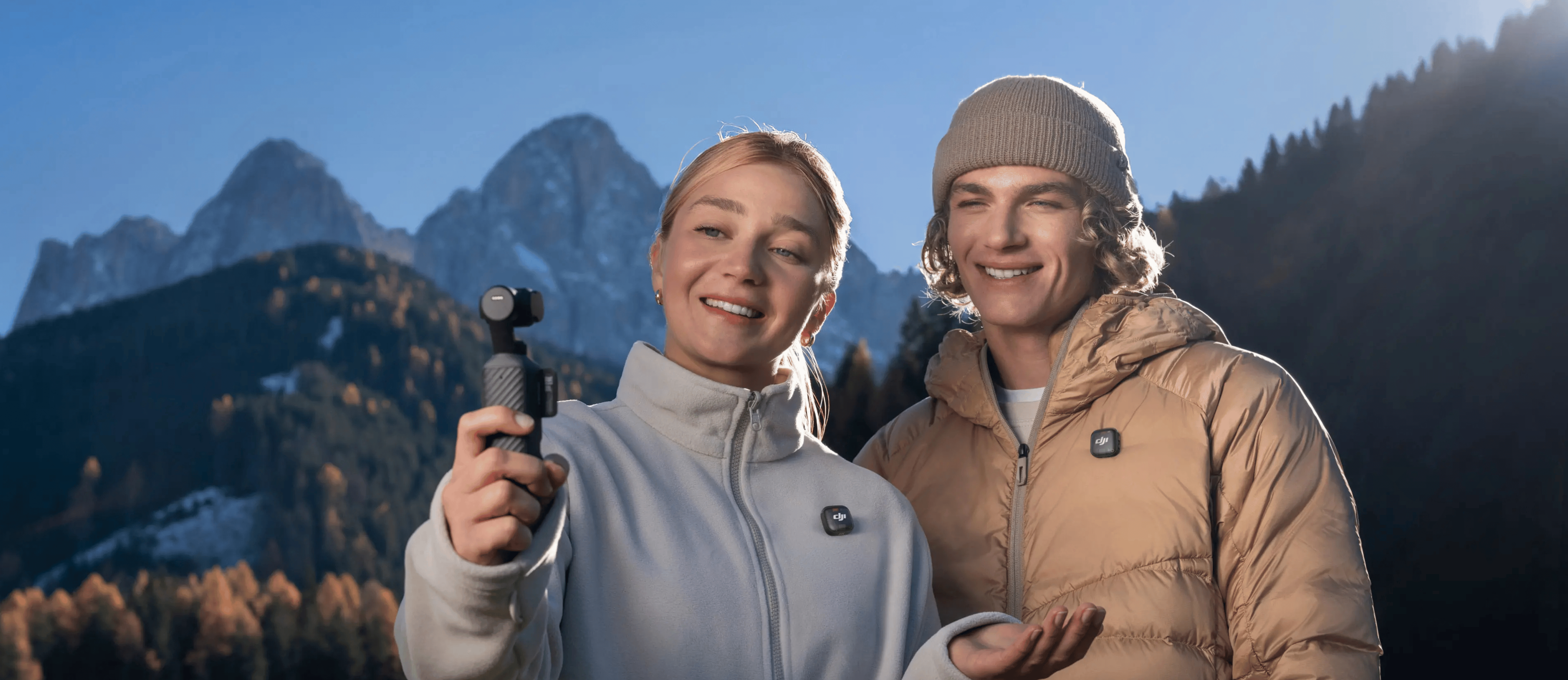 People with mountain backdrop holding DJI product